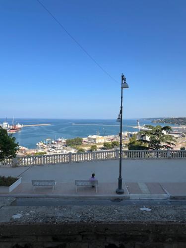 a person sitting on a bench overlooking the ocean at Casa Gigì in Ortona