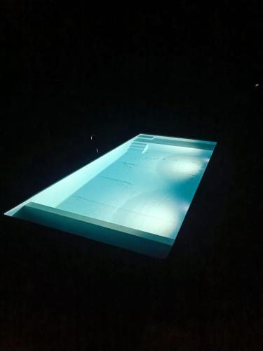 a tablet is lit up in the dark at Fragas do Cabril Eco & Wellness Lodge in Lousã