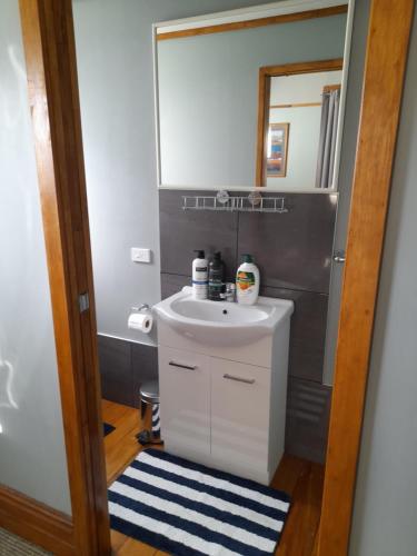 a bathroom with a sink and a mirror at Great place to stay in Gisborne