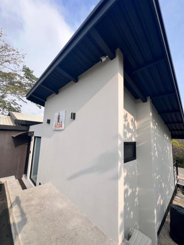 a white building with a blue roof at Guanacaste Marbella luxury home with a private pool in Santa Cruz