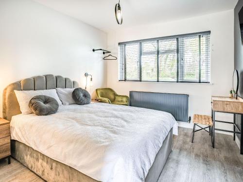 a bedroom with a large bed with two pillows on it at Cefn Gelli in Clynderwen