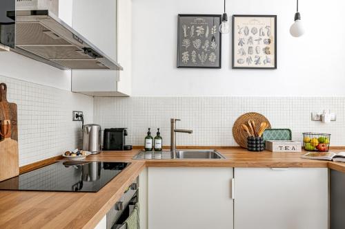 a kitchen with white cabinets and a sink at Hidden gem in the very heart of the city in Budapest