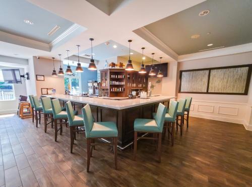 a large dining room with a large table and chairs at Hampton Inn & Suites Jekyll Island in Jekyll Island