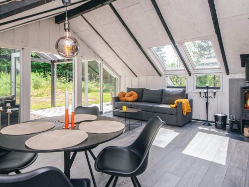 a living room with tables and chairs and a couch at 5 person holiday home in Silkeborg in Silkeborg