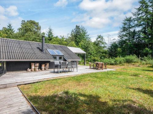 an image of a house with a deck and a fire pit at 5 person holiday home in Silkeborg in Silkeborg