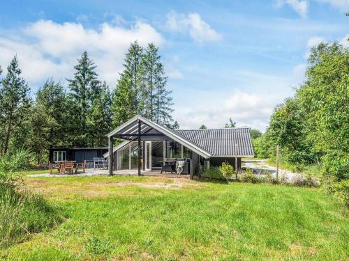 a small house with a metal roof at 5 person holiday home in Silkeborg in Silkeborg