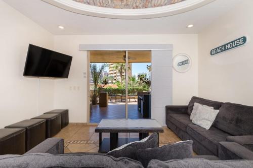 a living room with a couch and a tv at Bella Sirena 2BR 2BA 1st FL Spacious Patio B104 in La Choya