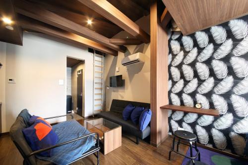 a living room with a couch and a table at S-rea TOKYO in Tokyo