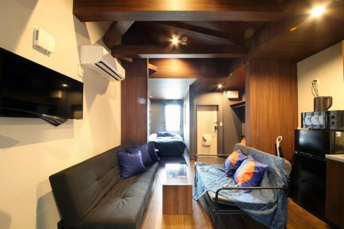 a living room with a couch and a table at S-rea TOKYO in Tokyo