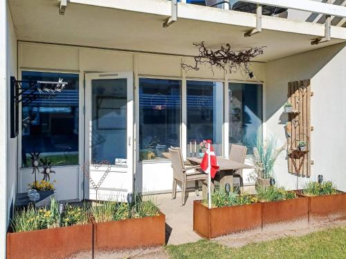 a porch of a house with a table and chairs at 4 person holiday home in Ringkøbing-By Traum in Ringkøbing