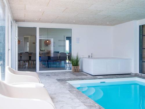 a living room with a swimming pool and a house at 5 star holiday home in Glesborg in Glesborg
