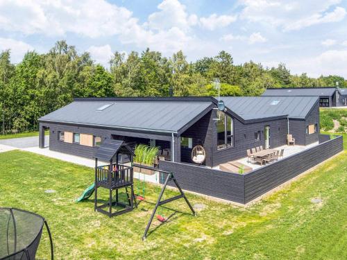 a modular home with a playground and a house at 5 star holiday home in Glesborg in Glesborg