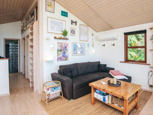 a living room with a couch and a table at 4 person holiday home in Glesborg in Glesborg
