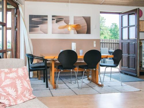 a dining room with a wooden table and chairs at 4 person holiday home in Glesborg in Glesborg