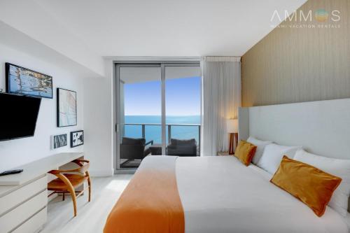 a bedroom with a bed and a tv and a window at 2 BR stunning views on the 18th floor! Miami in Hallandale Beach