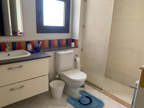 a bathroom with a toilet and a sink at Blanca, Marassiمراسي العلمين in El Alamein