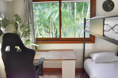 a bedroom with a desk and a bed and a window at Huge Hidden Hinterland Estate in Canungra