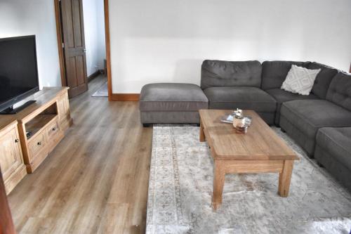 a living room with a couch and a coffee table at Huge Hidden Hinterland Estate in Canungra
