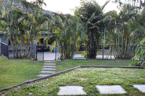 a garden with a gate and some grass and trees at Huge Hidden Hinterland Estate in Canungra