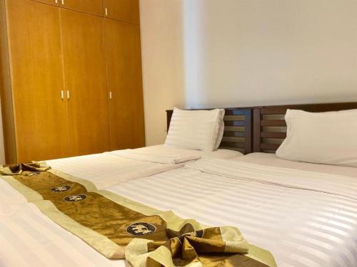two twin beds with bows on them in a bedroom at Homara in Gilgit