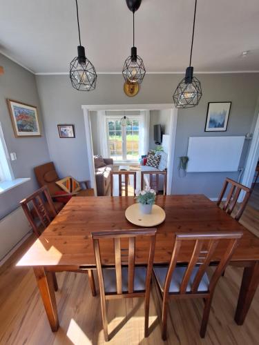 a dining room with a wooden table and chairs at Hallfreðarstaðir 1 Apartments in Hallfreðarstaðir
