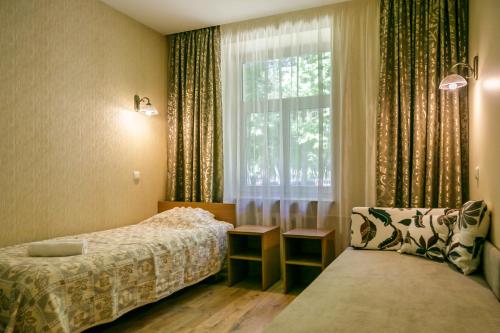 a hotel room with two beds and a window at Raze in Palanga