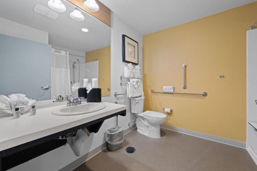 a bathroom with a sink and a toilet at River Inn at Seaside in Seaside