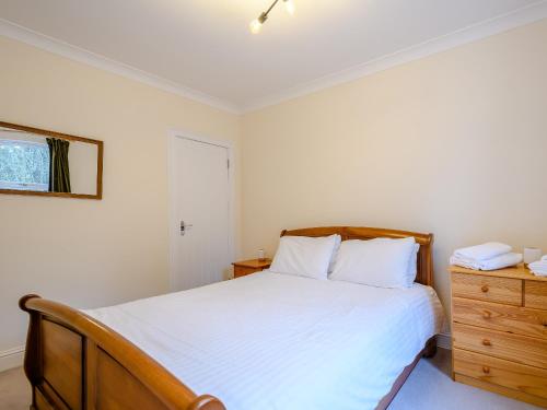 a bedroom with a bed and a dresser at Great Whaup in Coulter