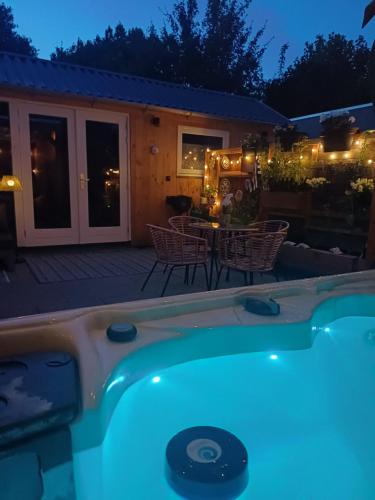 a hot tub in a backyard at night at Zeeuws Huusje in Middelburg