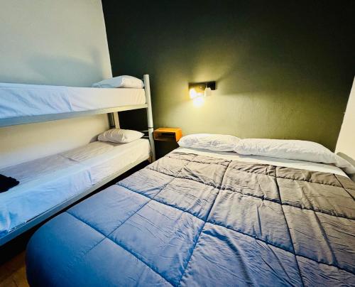 a bedroom with two bunk beds in a room at Lacandona Hostel in Cordoba