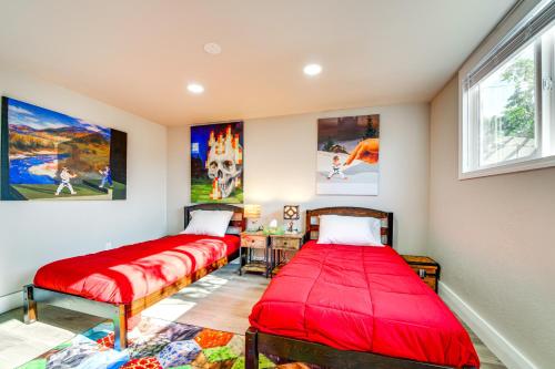 two beds in a room with paintings on the wall at 3 Mi to Dtwn Family Home with Garden and EV Charger in Yakima