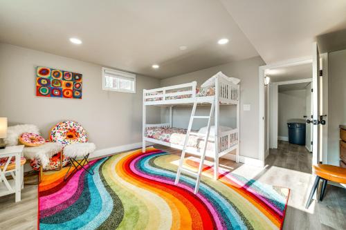 a room with two bunk beds on a rainbow rug at 3 Mi to Dtwn Family Home with Garden and EV Charger in Yakima