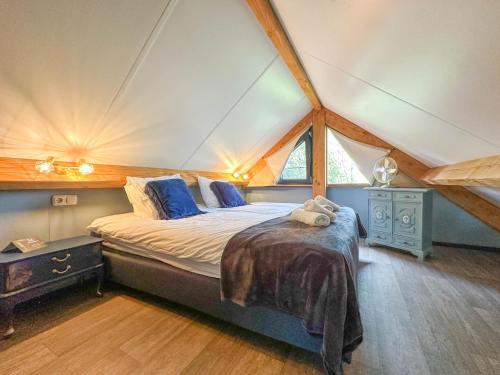 a bedroom with a bed in a tent at Onirico in Alphen