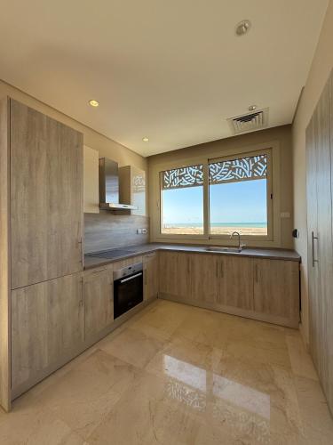 a large kitchen with a sink and a window at Boutique Residence Mangroovy-Lemon Spaces Gouna in Hurghada