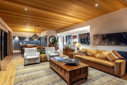 a living room with a couch and a table at Moa Luxe - Stay Waiheke in Waiheke Island