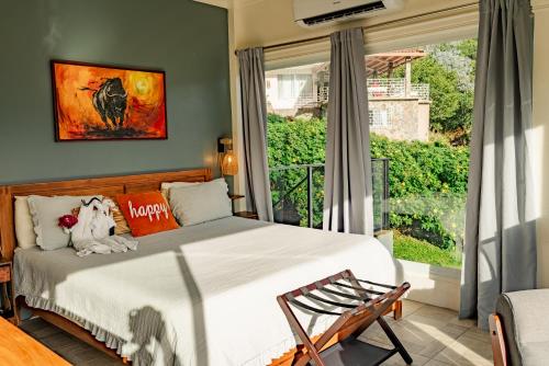 a bedroom with a bed and a large window at Casa Ejecutiva Boquete in Boquete