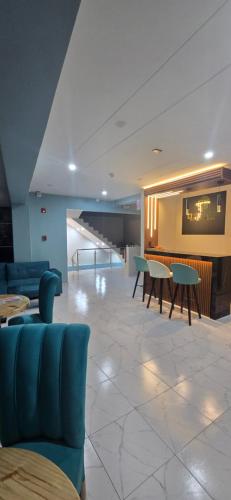 a lobby with tables and chairs in a building at CLUB 33 FIT Hotel Gym in Huancayo