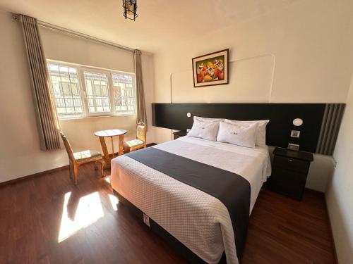 a bedroom with a large bed and a table at FRIENDLY AQP in Arequipa