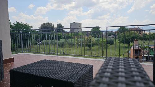 a balcony with a black table and a fence at Torre Serena B&B in Atella