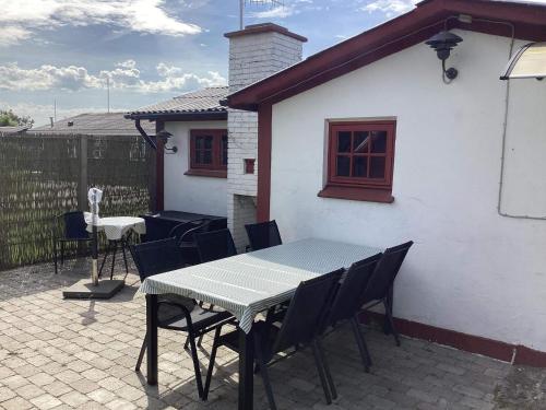 a table and chairs sitting outside of a house at 6 person holiday home in Løgstør in Løgstør