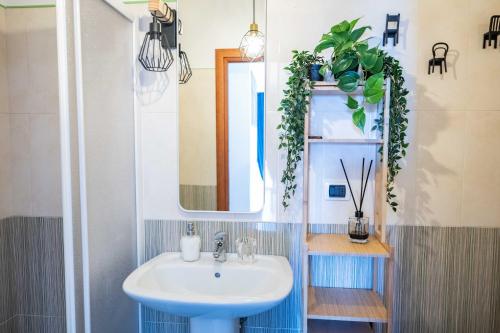 a bathroom with a sink and a mirror at A Me Casa - Taormina in Taormina
