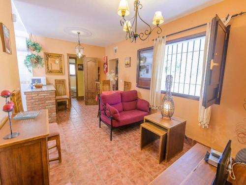 a living room with a red couch and a table at Studio in Spain with Private Pool and Garden in Rivero de Posadas