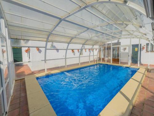a large swimming pool with a large ceiling at Studio in Spain with Private Pool and Garden in Rivero de Posadas
