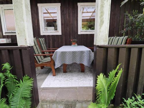 a table and chairs on the porch of a house at 4 person holiday home in ÖRKELLJUNGA in Orkelljunga