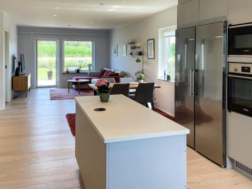 a kitchen and living room with a refrigerator and a table at 5 star holiday home in MÖRBYLÅNGA in Mörbylånga