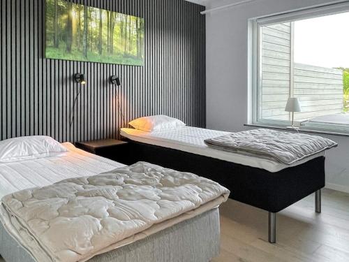 two beds sitting in a room with a window at 5 star holiday home in MÖRBYLÅNGA in Mörbylånga