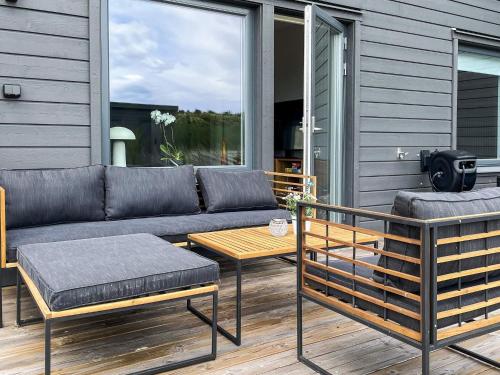 a patio with a couch and a coffee table at 5 star holiday home in MÖRBYLÅNGA in Mörbylånga