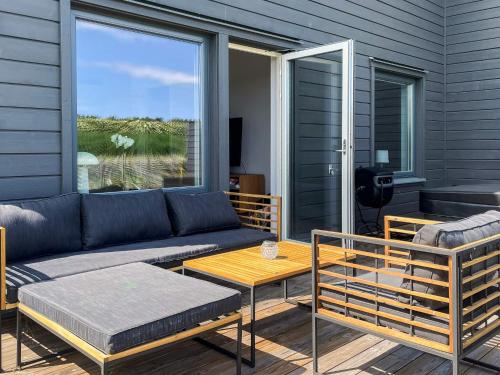 a living room with a couch and a table at 5 star holiday home in MÖRBYLÅNGA in Mörbylånga