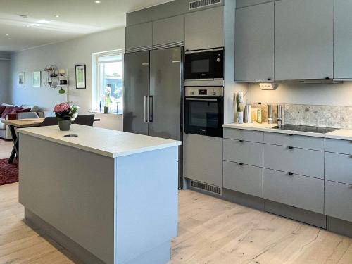 a kitchen with gray cabinets and a white counter top at 5 star holiday home in MÖRBYLÅNGA in Mörbylånga