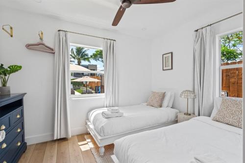 a bedroom with two beds and a window at Sleeps 11 Walk to Atlantic Pool w Sun Deck in Delray Beach
